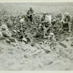 Resting in a shell hole, Amiens, 1918 Canadian War Museum eo-2959